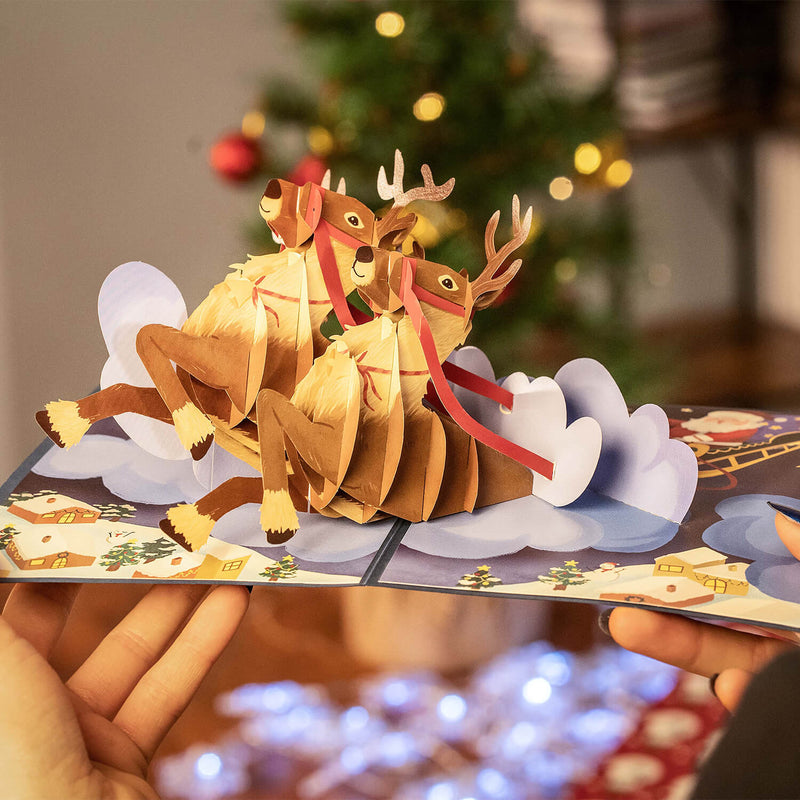 Biglietto pop-up con slitta con renne